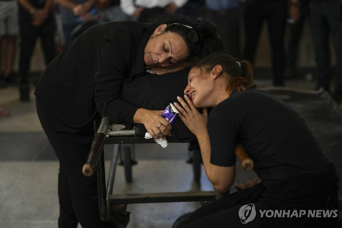 11일(현지시간) 이스라엘 텔아비브에서 열린 한 장례식에서 하마스에 의해 살해된 이의 유족들이 울고 있다. / 텔아비브 AP=연합뉴스