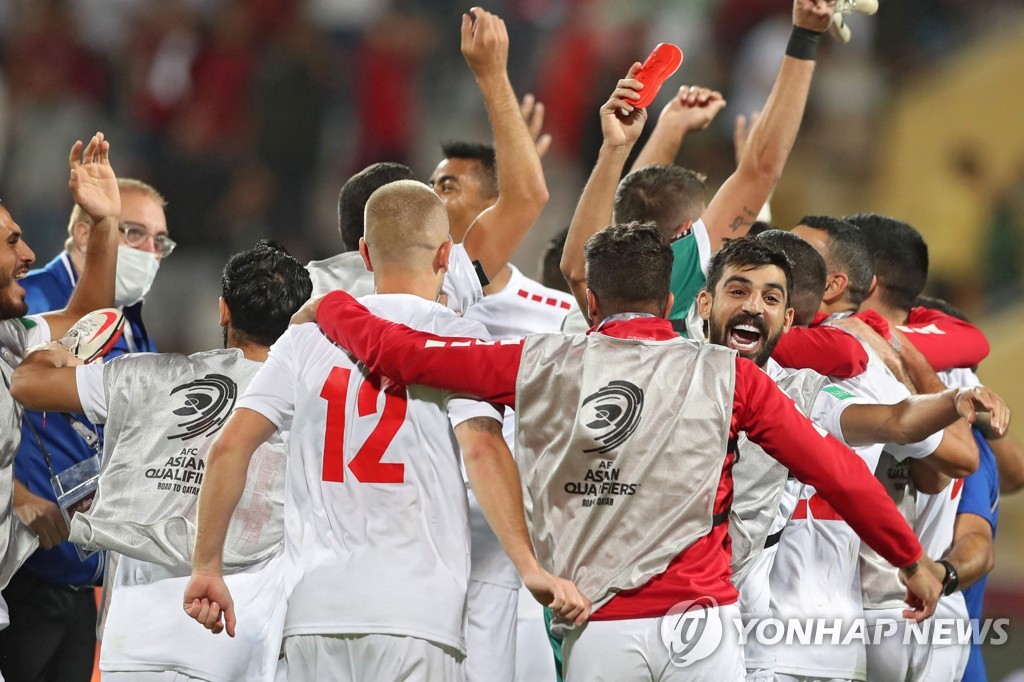 In this AFP photo, Lebanese players celebrate their 3-2 win over Syria in the teams' Group A match in the final Asian qualifying round for the 2022 FIFA World Cup at King Abdullah II Stadium in Amman on Oct. 12, 2021. (Yonhap)