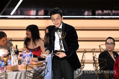 In this AFP photo, South Korean director Hwang Dong-hyuk accepts the award for Outstanding Directing For A Drama Series for "Squid Game" at the 74th Emmy Awards at the Microsoft Theater in Los Angeles, California, on Sept. 12, 2022 (U.S. time). (Yonhap)
