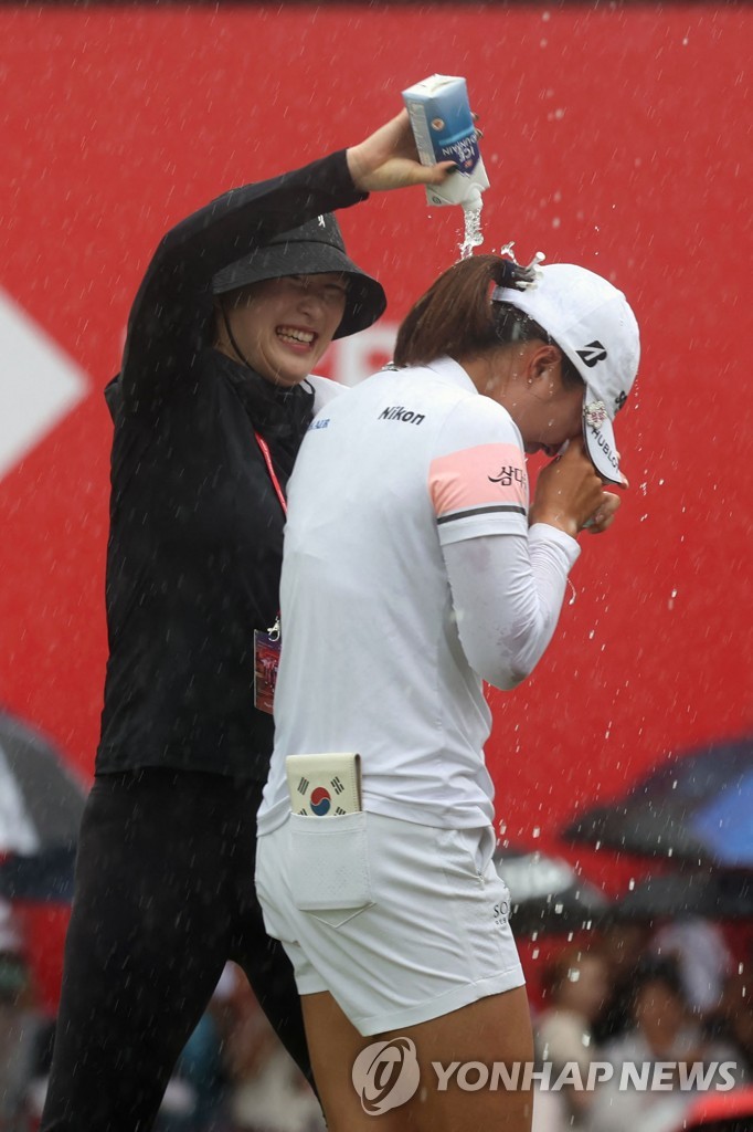 In this AFP photo, Ko Jin-young of South Korea (R) is congratulated by a friend after winning the HSBC Women's World Championship at Sentosa Golf Club's Tanjong Course in Singapore on March 5, 2023. (Yonhap)