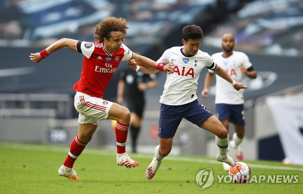 In this EPA photo, Son Heung-min of Tottenham Hotspur (R) battles David Luiz of Arsenal in the clubs' Premier League match at Tottenham Hotspur Stadium in London on July 12, 2020. (Yonhap)