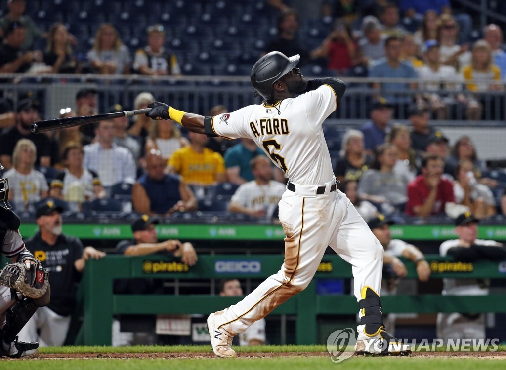 In this Getty Images file photo from Aug. 24, 2021, Anthony Alford of the Pittsburgh Pirates hits a two-run home run against the Arizona Diamondbacks during the bottom of the fourth inning of a Major League Baseball regular season game at PNC Park in Pittsburgh. (Yonhap)