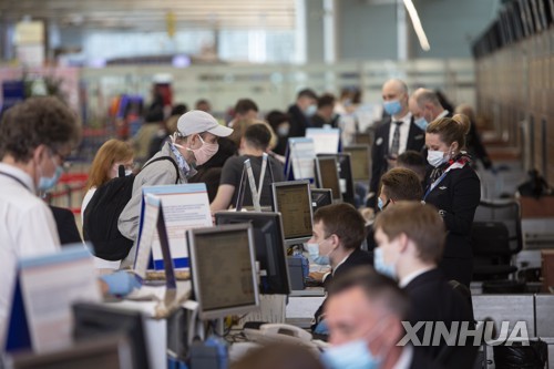 (신화=연합뉴스) 러시아가 국제선 항공편 운항을 재개한 1일 (현지시간) 모스크바 셰레메티예보 국제공항에서 승객들이 탑승 수속을 밟고 있다.