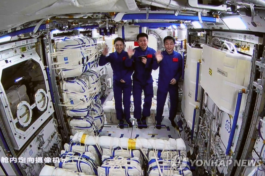 (신화=연합뉴스) 지난 3일 중국 우주비행사들이 우주정거장 톈궁의 두번째 실험실 모듈 멍톈에서 손을 흔드는 모습. 2022.11.4.