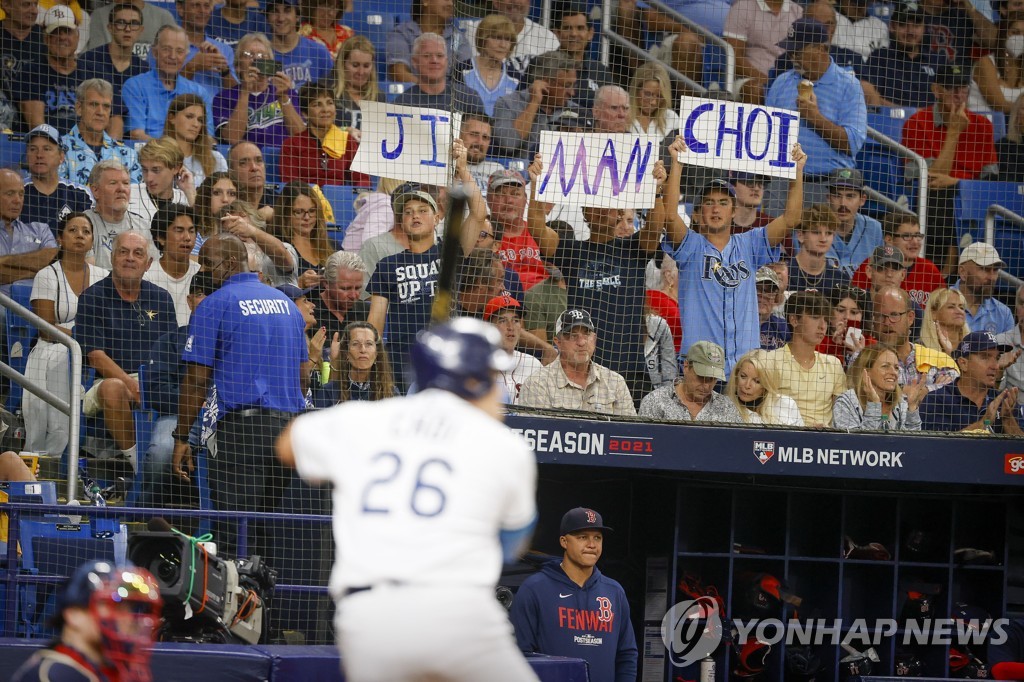 In this USA Today Sports photo via Reuters, fans of the Tampa Bay Rays hold up signs showing the name of the team's first baseman Choi Ji-man during Choi's at-bat against the Boston Red Sox in the bottom of the fourth inning of Game 2 of the American League Division Series at Tropicana Field in St. Petersburg, Florida, on Oct. 8, 2021. (Yonhap)