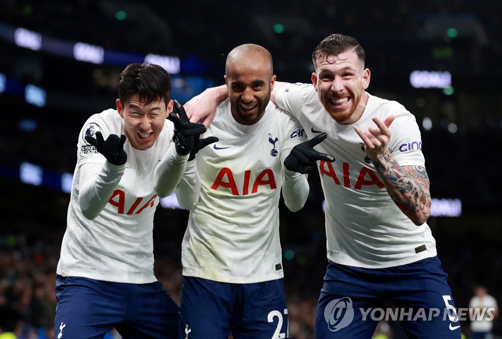 In this Reuters photo, Son Heung-min of Tottenham Hotspur (L) celebrates his goal against Norwich City with teammates Lucas Moura (C) and Pierre-Emile Hojbjerg during a Premier League match at Tottenham Hotspur Stadium in London on Dec. 5, 2021. (Yonhap)