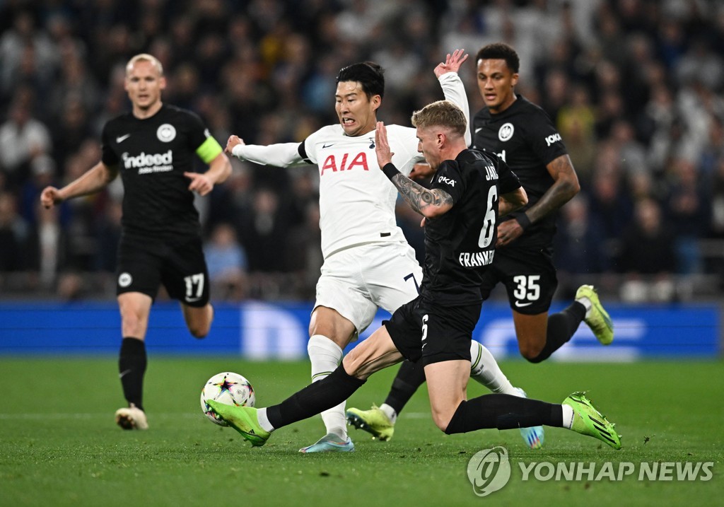 In this Reuters photo, Son Heung-min of Tottenham Hotspur (C) is challenged by Kristijan Jakic of Eintracht Frankfurt during the teams' Group D match at the UEFA Champions League at Tottenham Hotspur Stadium in London on Oct. 12, 2022. (Yonhap)