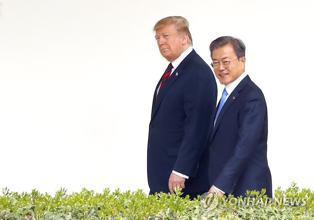 In this file photo, taken April 11, 2019, South Korean President Moon Jae-in (R) and U.S. President Donald Trump walk in the Rose Garden of the White House in Washington as they head to a meeting venue. (Yonhap) 