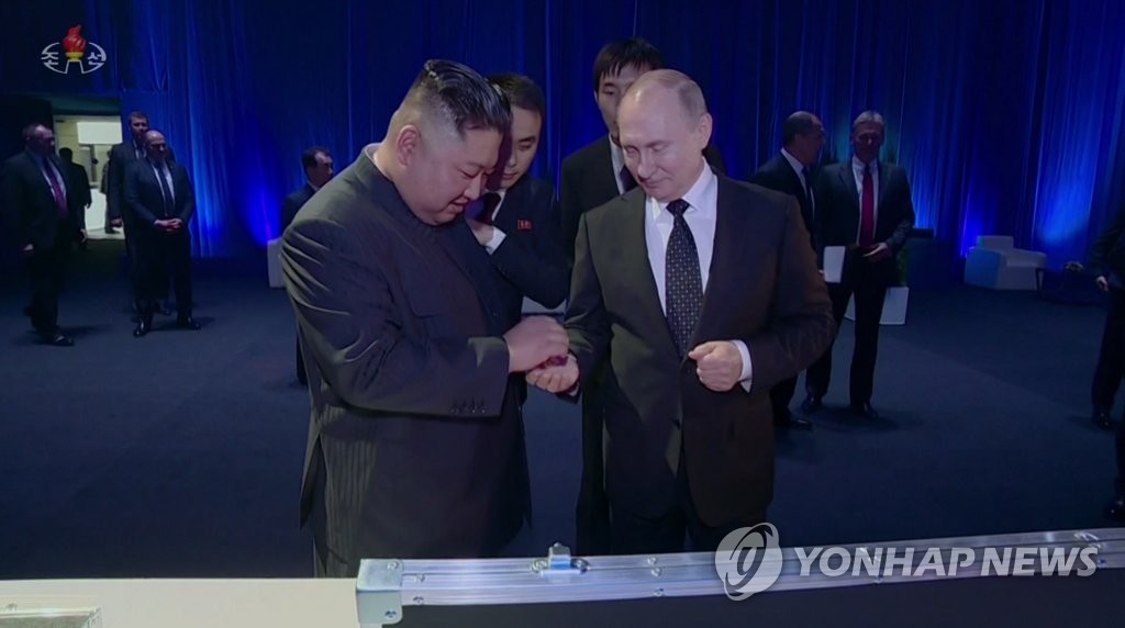 This image, captured from the Korean Central TV Broadcasting Station on April 28, 2019, shows North Korean leader Kim Jong-un handing a coin to Russian President Vladimir Putin during their summit in Vladivostok the previous week. The station aired a 50-minute documentary on Kim's visit to the port city in eastern Russia. (For Use Only in the Republic of Korea. No Redistribution) (Yonhap)