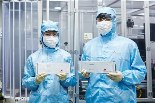 This undated photo provided by SK Innovation Co. shows its researchers holding battery cells for electric vehicles. (PHOTO NOT FOR SALE) (Yonhap)
