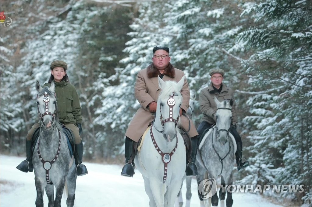North Korean leader Kim Jong-un (C) rides a white horse up a snow-covered Mount Paekdu, the country's highest peak on the border with China, after inspecting construction sites at the foot of the mountain, in this footage aired by the North's Korean Central Television on Oct. 16, 2019. Kim is accompanied by senior party officials, including his sister, Kim Yo-jong (L) and Jo Yong-won. (For Use Only in the Republic of Korea. No Redistribution) (Yonhap)