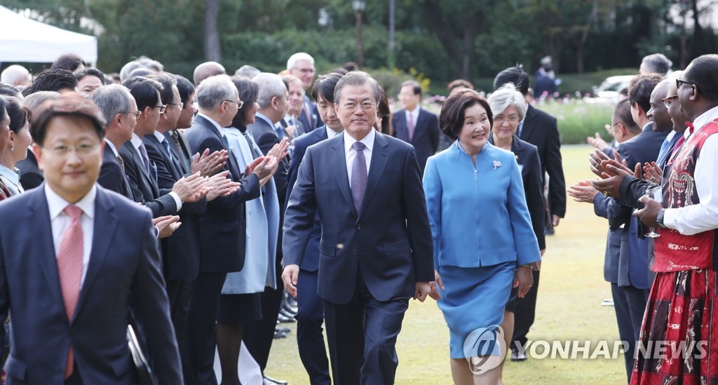 President Moon Jae-in and first lady Kim Jung-sook arrive at the Nokjiwon garden in Cheong Wa Dae, in Seoul, for a reception with foreign ambassadors and their spouses on Oct. 18, 2019. (Yonhap)