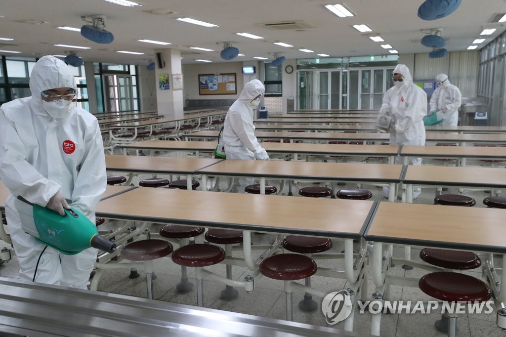 Health authorities disinfect a high school cafeteria in the southeastern Seoul ward of Songpa on May 6, 2020. (Yonhap)