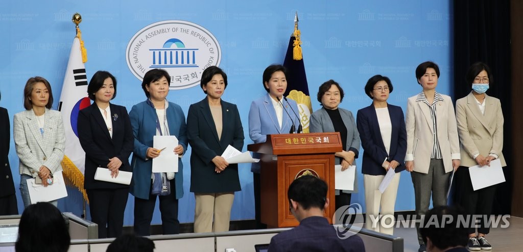 In this file photo, female lawmakers of the ruling Democratic Party hold a press conference at the National Assembly in Seoul on May 12, 2020. (Yonhap)