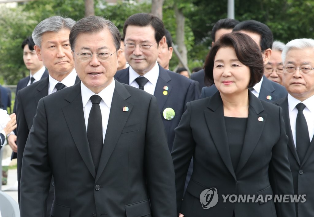President Moon Jae-in (L) and first lady Kim Jung-sook attend an official ceremony to mark the 40th anniversary of the May 18 Democratization Movement in Gwangju, 270 kilometers south of Seoul, on May 18, 2020. (Yonhap)