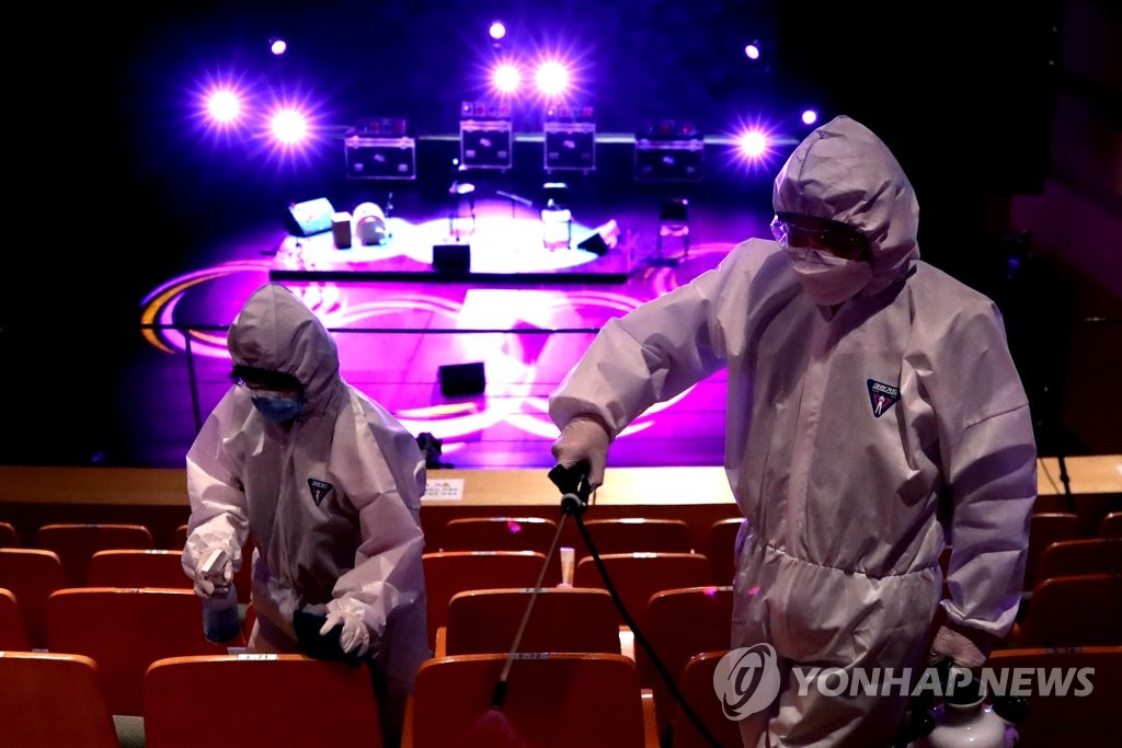 Quarantine officials disinfect seats at Mapo Art Center in western Seoul on May 21, 2020, as it prepares to resume the operation on May 26 after a 107-day hiatus over the new coronavirus. (Yonhap)