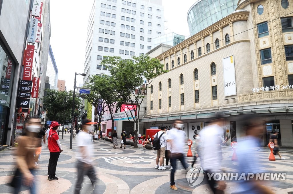 This photo, taken on July 31, 2020, shows people walking in Myeongdong, one of the busiest shopping districts in Seoul. (Yonhap)