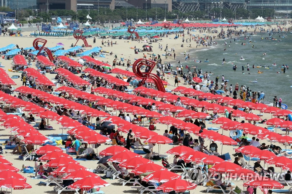 People relax at Haeundae Beach in the southeastern port city of Busan on Aug. 16, 2020. (Yonhap)