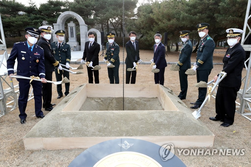 In this photo, provided by the Defense Media Agency, officials bury a time capsule to mark the 70th anniversary of the outbreak of the 1950-53 Korean War at the national cemetery in Seoul on Nov. 25, 2020. (PHOTO NOT FOR SALE) (Yonhap)
