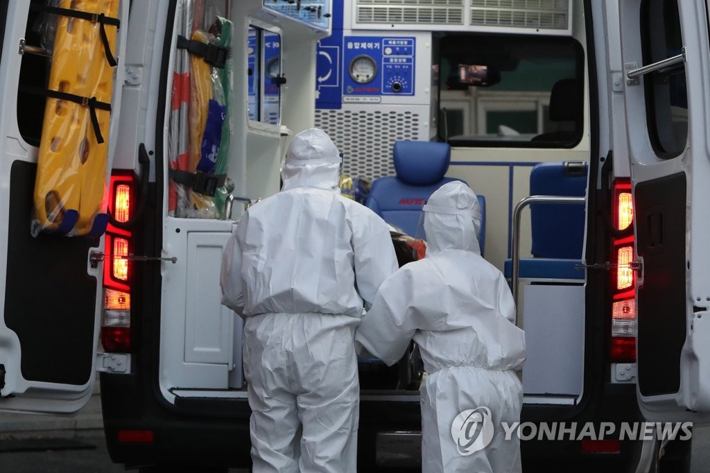 A COVID-19 patient is loaded into an ambulance at a nursing home in the southwestern city of Gwangju on Dec. 22, 2020, to be transported to a nearby hospital. Twelve residents and four workers have been diagnosed with the new coronavirus at the facility. (Yonhap)