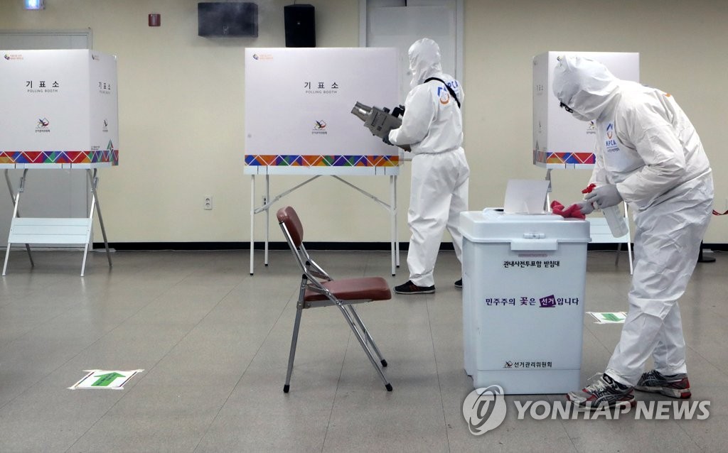 A polling station in a community center in the southeastern city of Busan is disinfected on April 1, 2021, one day before a two-day early voting begins for the April 7 mayoral by-election. (Yonhap)
