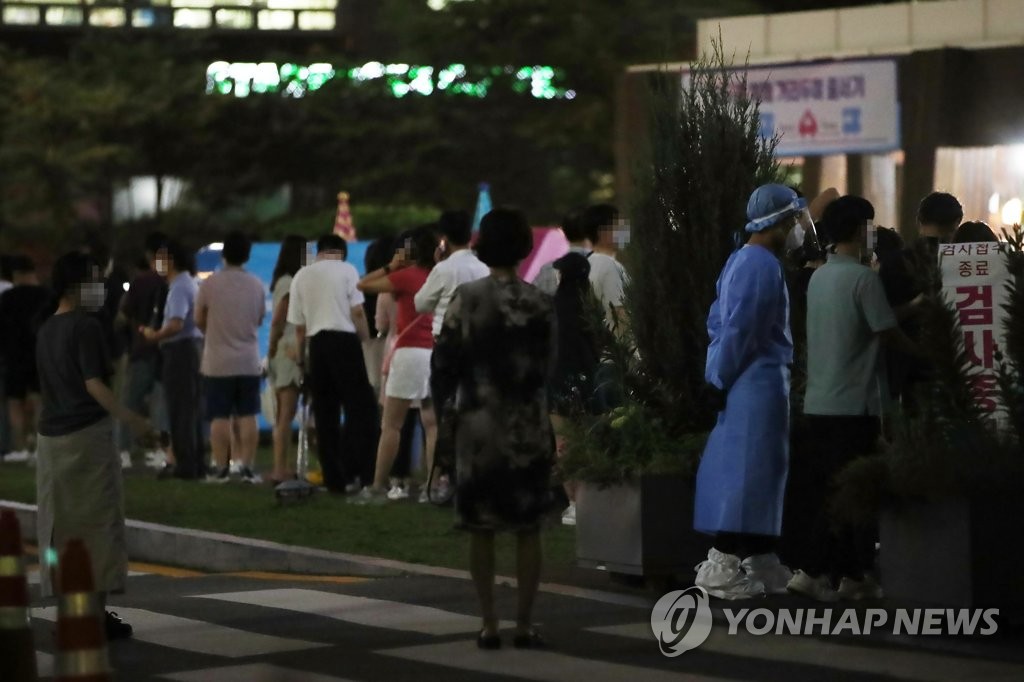 People wait in line to be tested for COVID-19 at a temporary testing site in Seoul on July 7, 2021. (Yonhap)