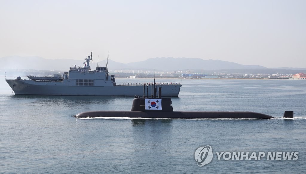 South Korea's first homegrown 3,000-ton submarine, the Dosan Ahn Chang-ho, navigates through the water while hoisting the national flag during a ceremony to mark the 73rd Armed Forces Day on the light aircraft carrier LPH Marado off the coast of Pohang, 374 kilometers southeast of Seoul, on Oct. 1, 2021. (Yonhap)