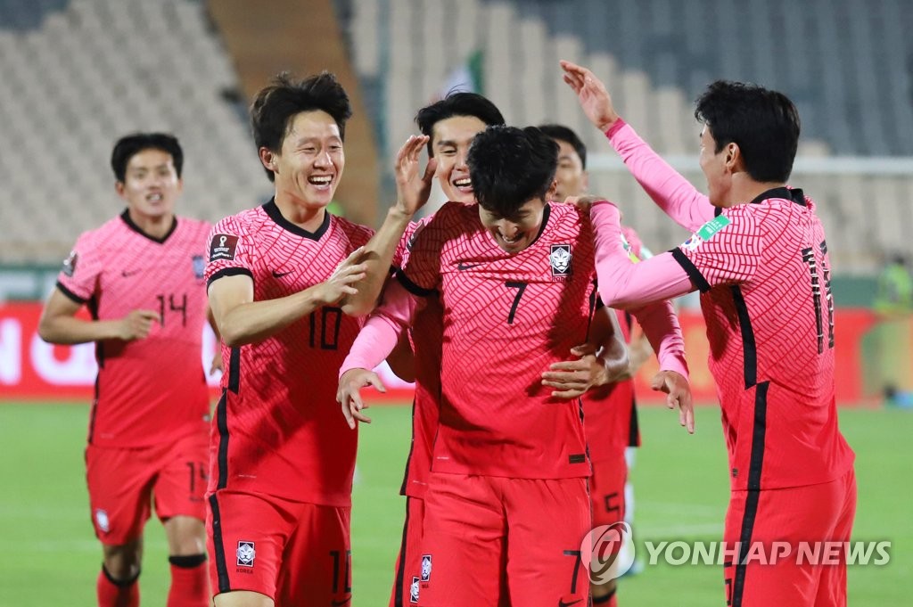 Son Heung-min of South Korea (C) is mobbed by teammates after scoring a goal against Iran during the teams' Group A match in the final Asian qualifying round for the 2022 FIFA World Cup at Azadi Stadium in Tehran on Oct. 12, 2021. (Yonhap)