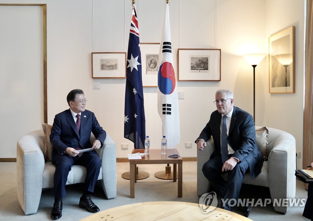 South Korean President Moon Jae-in (L) and Australian Prime Minister Scott Morrison hold summit talks at the Parliament House in Canberra on Dec. 13, 2021. Moon arrived in Australia the previous day for a four-day state visit. (Yonhap)