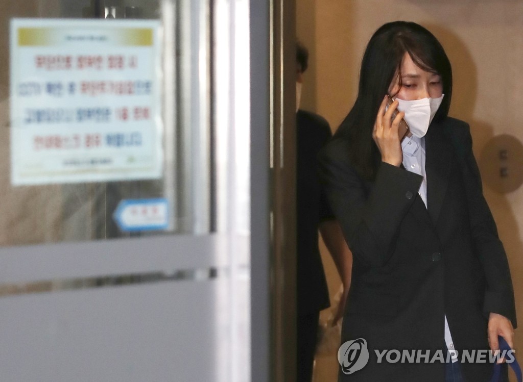 Kim Keon-hee, wife of the main opposition People Power Party's presidential candidate, Yoon Suk-yeol, makes a phone call as she leaves her residence in Seoul on Dec. 15, 2021, to head to her office. (Yonhap)