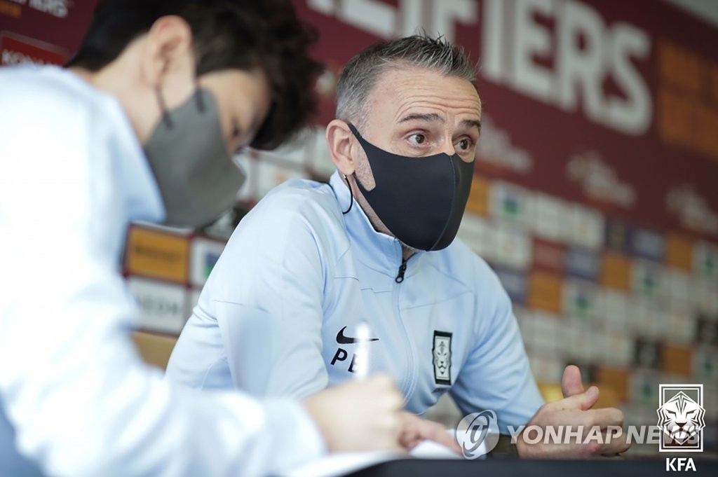 Paulo Bento (R), head coach of the South Korean men's national football team, speaks at a press conference at the National Football Center in Paju, Gyeonggi Province, on March 23, 2022, on the eve of a World Cup qualifying match against Iran, in this photo provided by the Korea Football Association. (PHOTO NOT FOR SALE) (Yonhap)