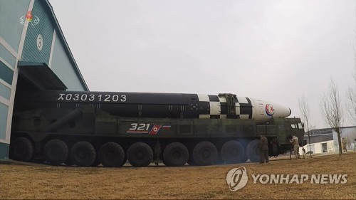 An intercontinental ballistic missile (ICBM) is moved from storage for a test at Pyongyang International Airport on March 24, 2022, in this photo captured from the North's Central TV the following day. (For Use Only in the Republic of Korea. No Redistribution) (Yonhap)
