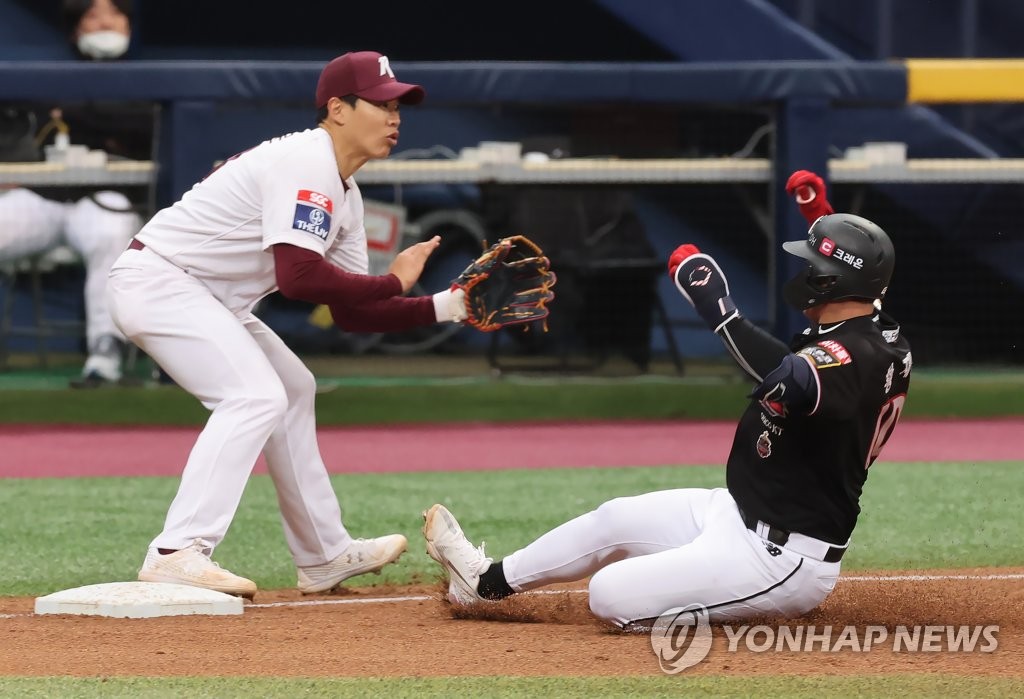 Hwang Jae-gyun of the KT Wiz (R) slides into third base after hitting a triple against the Kiwoom Heroes during the top of the fifth inning of a Korea Baseball Organization preseason game at Gocheok Sky Dome in Seoul on March 29, 2022. (Yonhap)