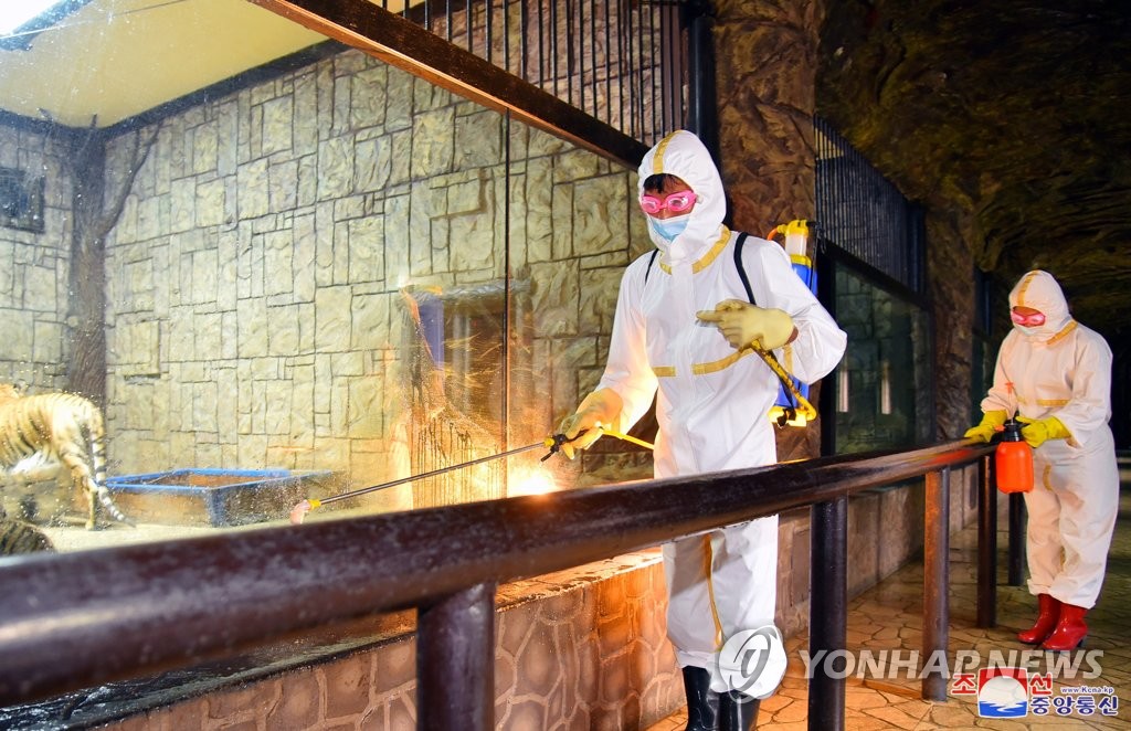 North Korean health care workers disinfect the Pyongyang zoo, in this photo from the state-run Korean Central News Agency on May 20, 2022, amid an outbreak of COVID-19. (For Use Only in the Republic of Korea. No Redistribution) (Yonhap)