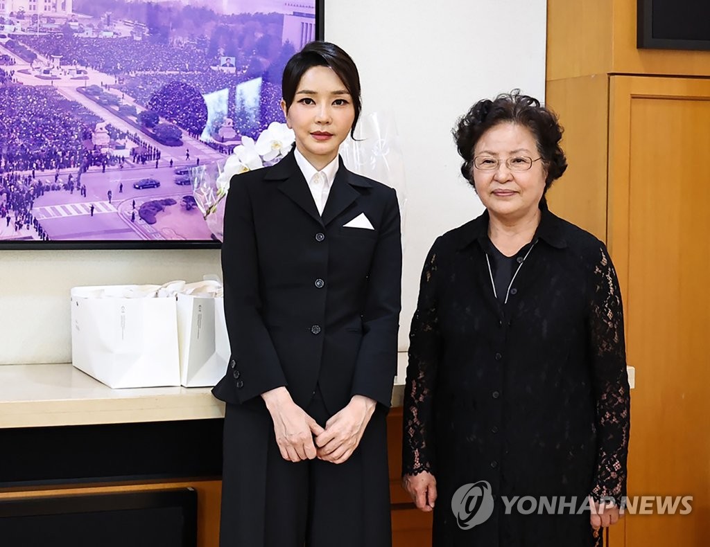 First lady Kim Keon-hee (L) poses for a photo with Kwon Yang-sook, the widow of former President Roh Moo-hyun, during her visit to Kwon's home in the southeastern village of Bongha, about 300 kilometers southeast of Seoul, on June 13, 2022, in this photo provided by the presidential office. (PHOTO NOT FOR SALE) (Yonhap)