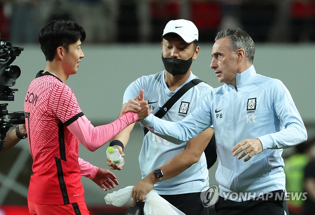 South Korea head coach Paulo Bento (R) and his captain Son Heung-min (L) celebrate their 4-1 victory over Egypt in the countries' friendly football match at Seoul World Cup Stadium in Seoul on June 14, 2022. (Yonhap)