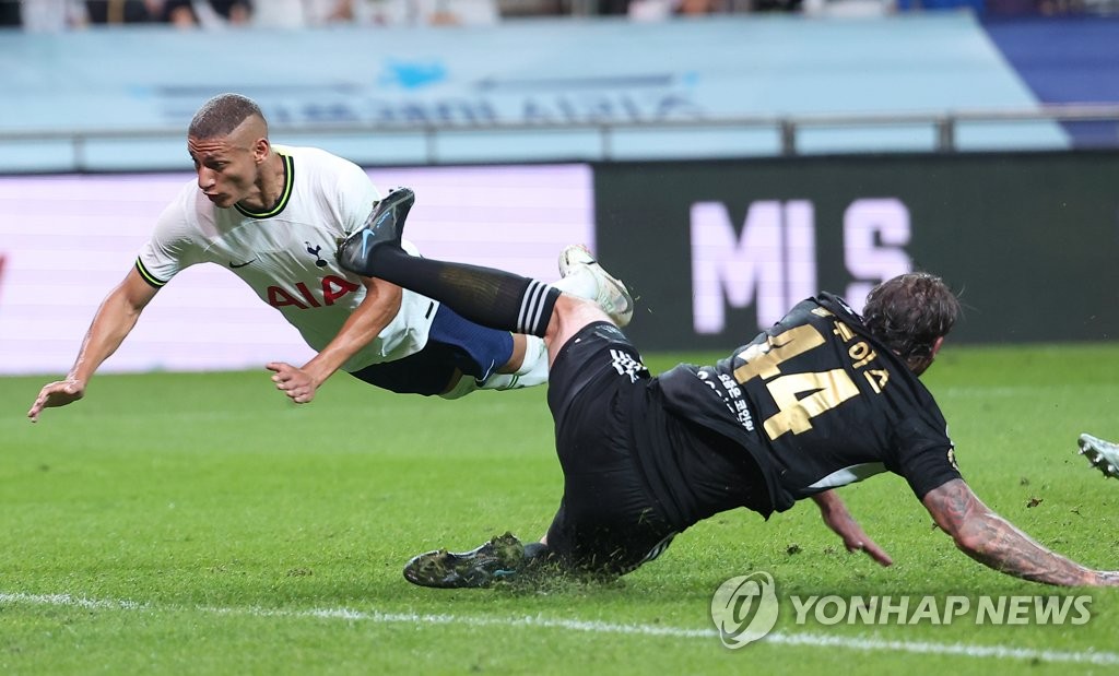 Dave Bulthuis of Team K League (R) clears the ball ahead of Richarlison of Tottenham Hotspur during the teams' exhibition match at Seoul World Cup Stadium in Seoul on July 13, 2022. (Yonhap)