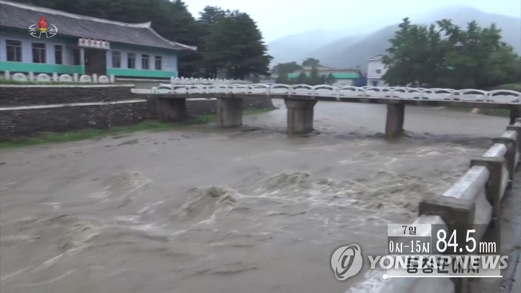 This captured footage from the North's Korean Central Television on Aug. 7, 2022, shows water gushing through a river amid heavy downpours. (For Use Only in the Republic of Korea. No Redistribution) (Yonhap)