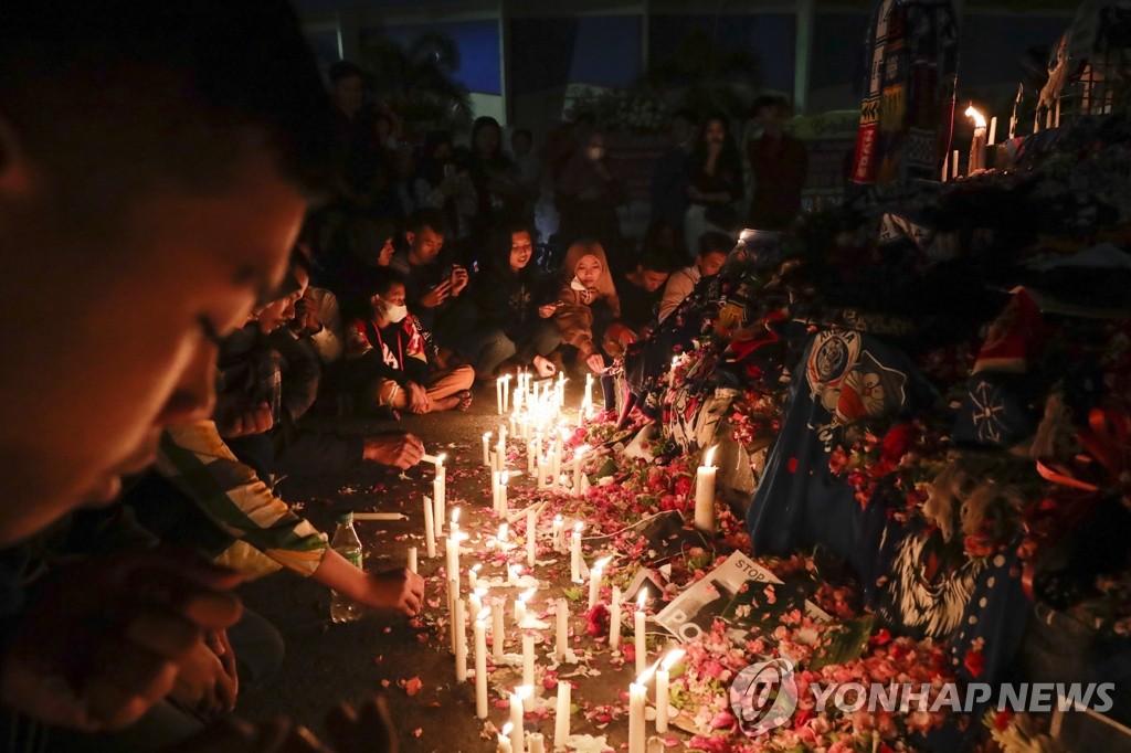 Candles lit at the site of the Indonesian football stadium disaster