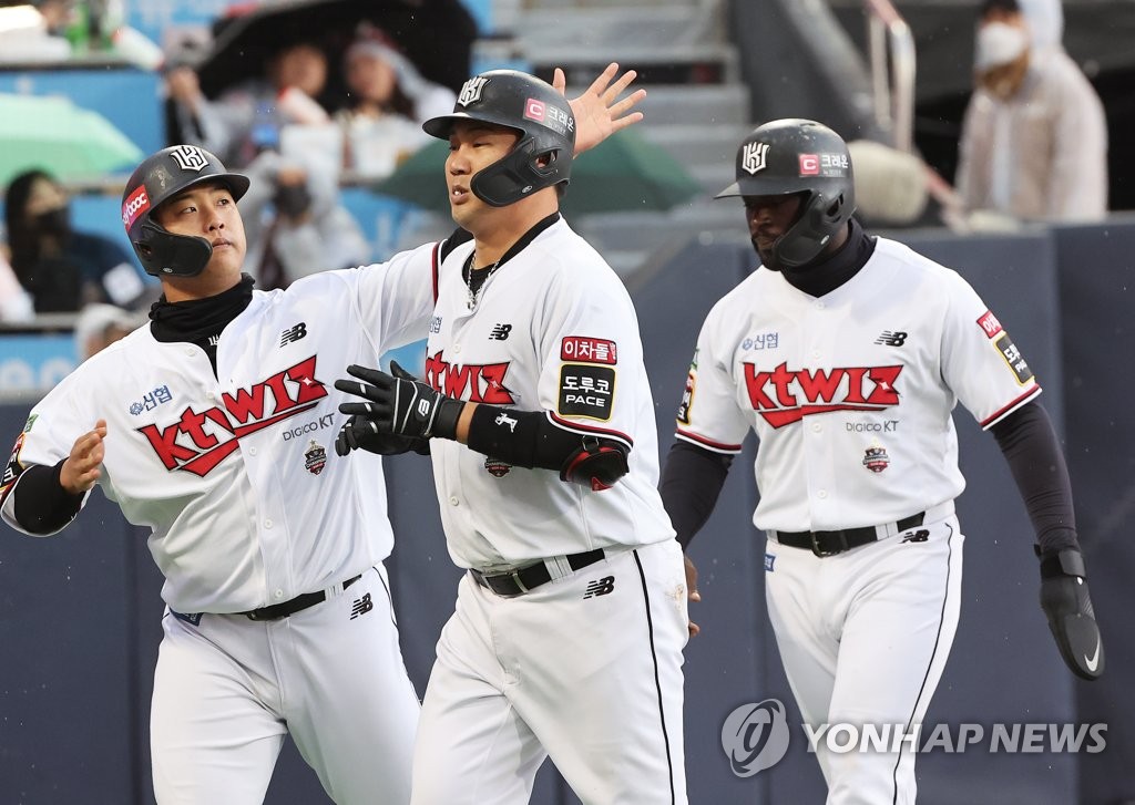 Jang Sung-woo of the KT Wiz (C) is congratulated by teammate Kang Baek-ho (L) after hitting a three-run home run against the NC Dinos during the bottom of the fourth inning of a Korea Baseball Organization regular season game at KT Wiz Park in Suwon, 35 kilometers south of Seoul, on Oct. 10, 2022. (Yonhap)