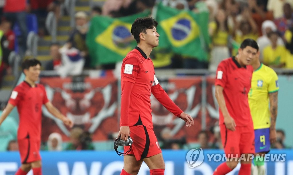 South Korean captain Son Heung-min (C) walks off the field after going down 4-0 against Brazil in the countries' round of 16 match at the FIFA World Cup at Stadium 974 in Doha on Dec. 5, 2022. (Yonhap)