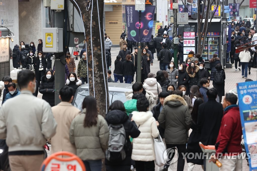 People walk on a street in central Seoul on Dec. 12, 2022. (Yonhap) 