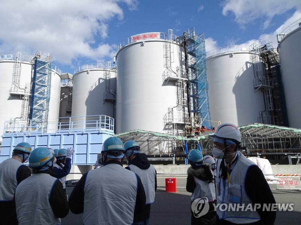 In this file photo, officials of Tokyo Electric Power Co., the operator of the crippled Fukushima nuclear plant, speak to journalists at Fukushima Daiichi Nuclear Power Station on Feb. 2, 2023. (Yonhap)