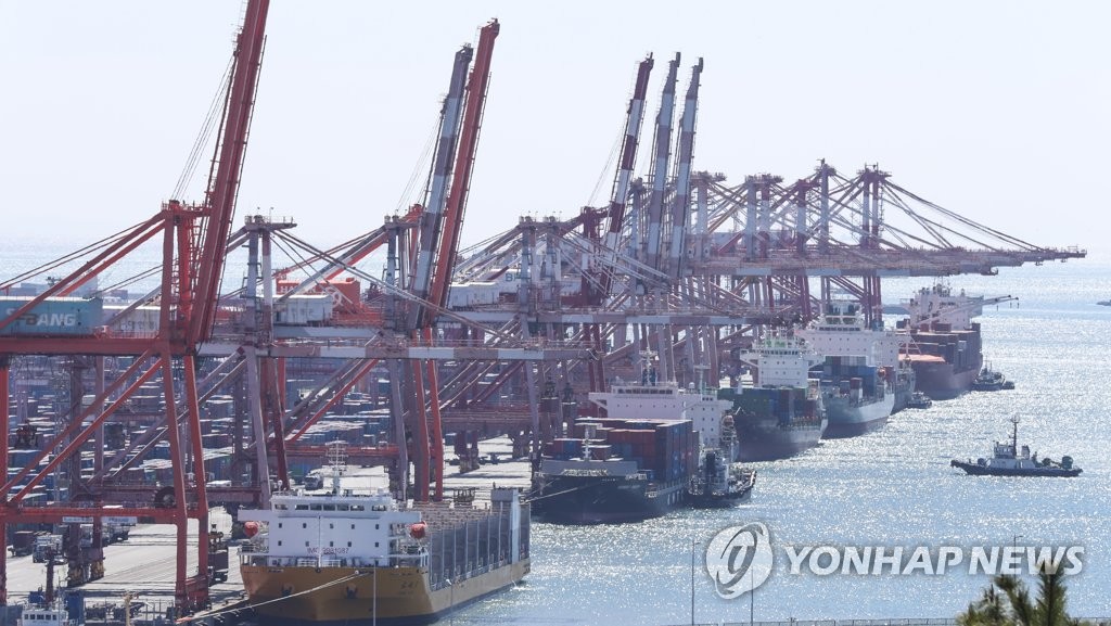 Cranes unload containers from carriers at Busan Port in the port city of Busan, 325 kilometers southeast of Seoul, in this file photo taken March 13, 2023. (Yonhap)