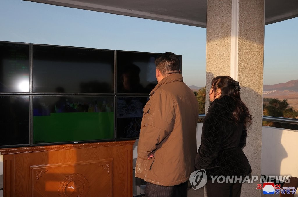 North Korean leader Kim Jong-un (L), alongside his daughter Ju-ae, inspects the test-firing of a Hwasong-17 intercontinental ballistic missile on March 16, 2023, in this photo released by the North's official Korean Central News Agency the following day. (For Use Only in the Republic of Korea. No Redistribution) (Yonhap)