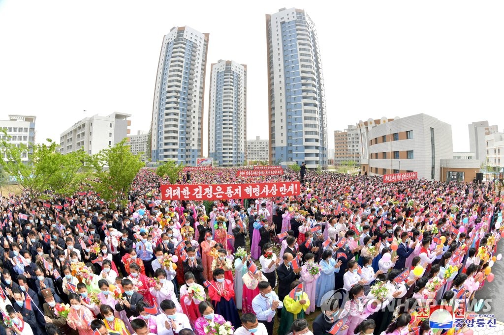 This photo, carried by North Korea's Korean Central News Agency on May 22, 2023, shows the North holding a ceremony to mark the completion of building new homes in the Taephyong district in Pyongyang. (For Use Only in the Republic of Korea. No Redistribution) (Yonhap)