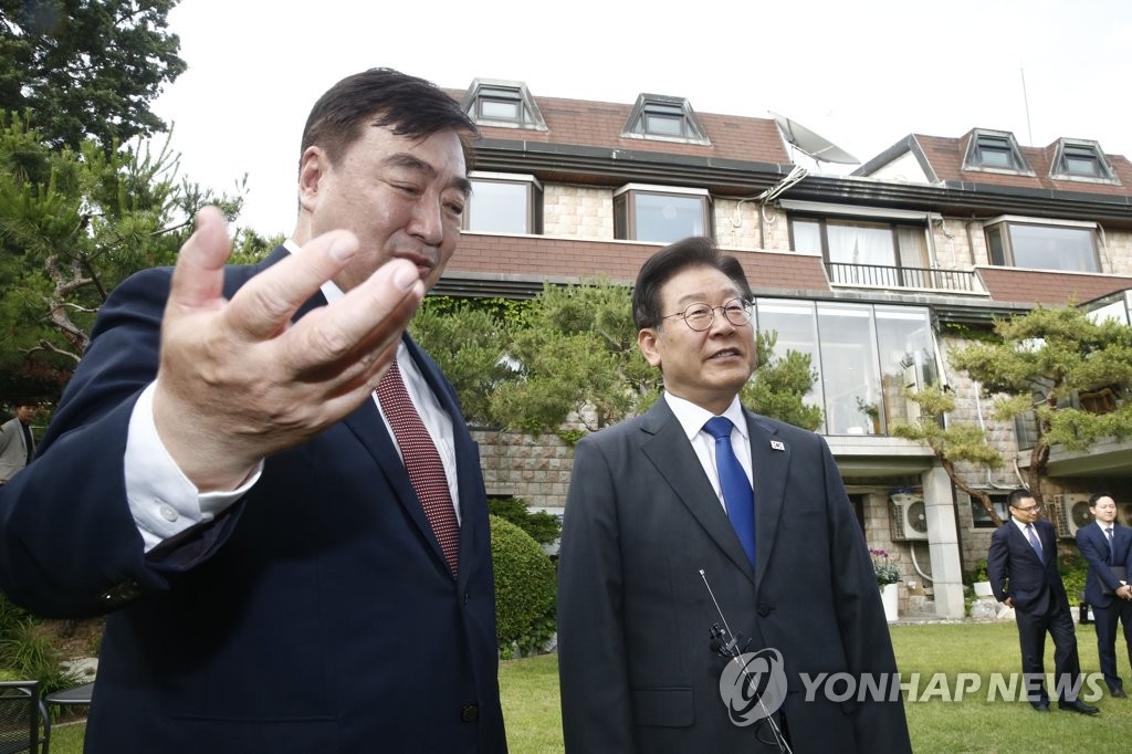 Main opposition Democratic Party leader Lee Jae-myung (R) is seen with Chinese Ambassador to South Korea Xing Haiming at the ambassador's residence in Seoul on June 8, 2023. (Yonhap)
