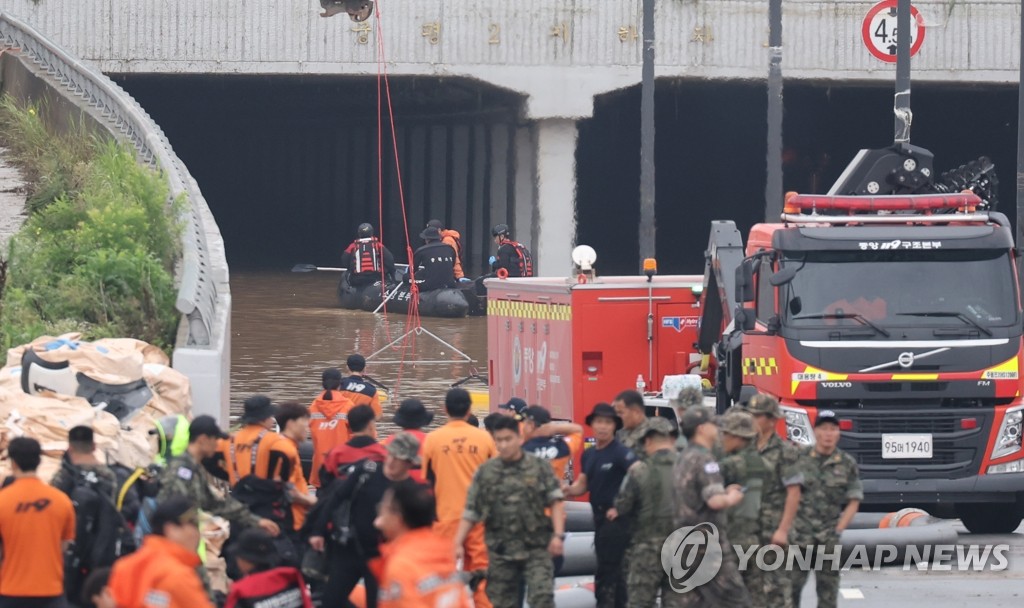 A search operation is under way on July 16, 2023, in a flooded underground tunnel in the central town of Osong. (Yonhap)
