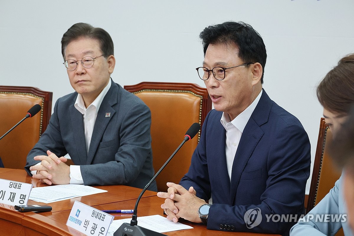 The main opposition Democratic Party's (DP) leader Lee Jae-myung (L) is seen next to the DP's floor leader Rep. Park Kwang-on during a meeting at the National Assembly in Seoul on Aug. 28, 2023. (Yonhap)
