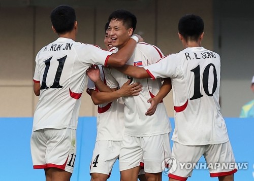 Ri Jo-guk of North Korea (2nd from R) is congratulated by teammates after scoring a goal against Chinese Taipei during the teams' Group F match in men's football at the Asian Games at Zhejiang Normal University East Stadium in Jinhua, China, on Sept. 19, 2023. (Yonhap)